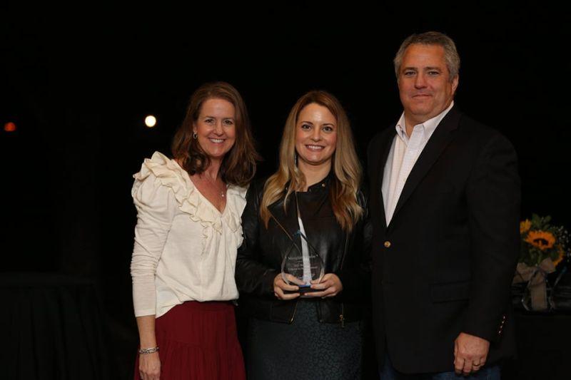 Meaghan Timko (center) receiving the LiveSafe Resources Woman of Achievement award, recognizing her contributions to the metro Atlanta philanthropic and business community.
