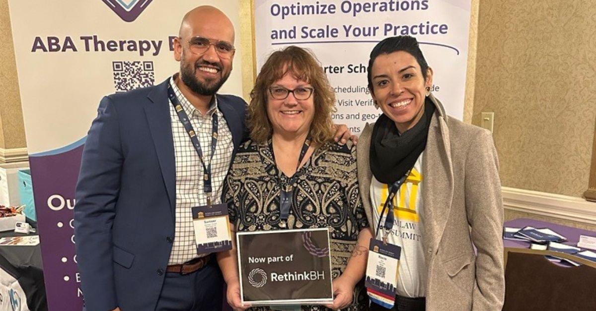 Michele Silcox-Beal (center) at an industry conference booth announcing the acquisition of ABA Therapy Billing and Insurance Services by RethinkBH, October 2023.