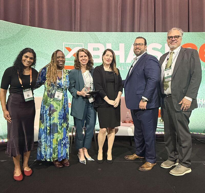 Pinney (center left) with fellow panelists and award recipients at BHASE 26, Miami.