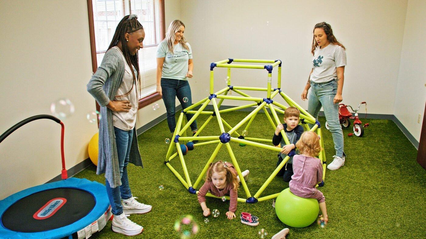 An ABA therapy team works with children in a center-based setting