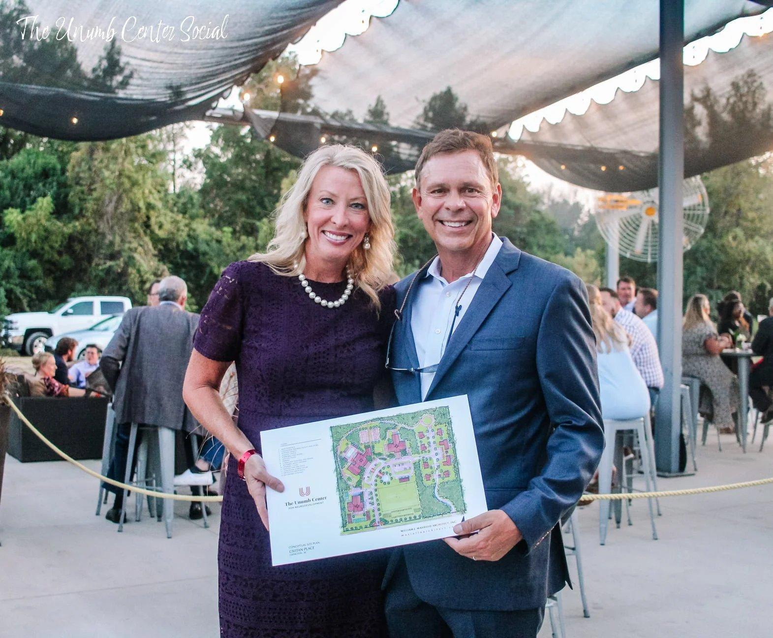 Dan and Lorri Unumb display the conceptual site plan for Unumb Place