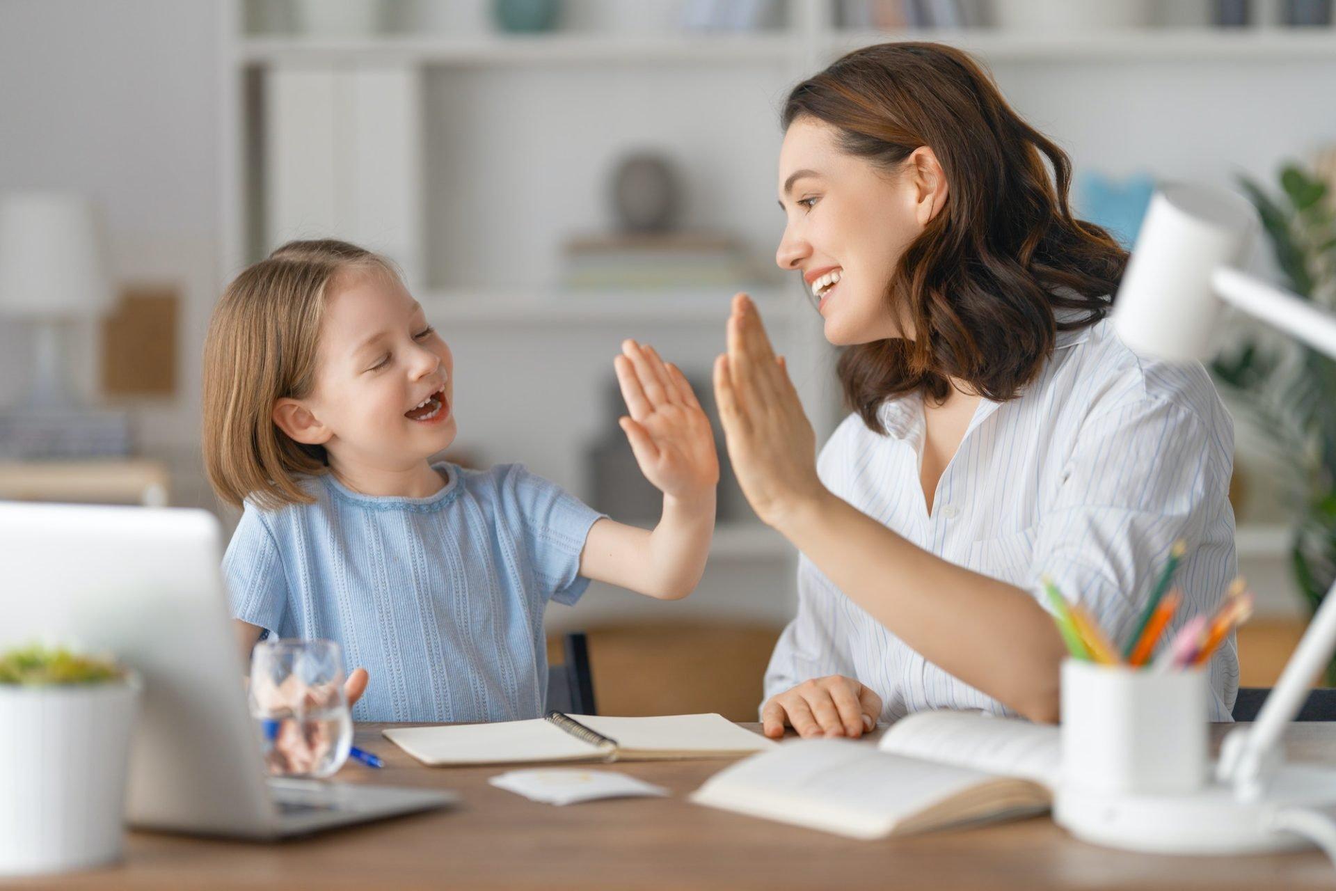 A parent works with her child at home using structured learning activities — the kind of parent-mediated intervention that multiple meta-analyses have shown can produce meaningful gains during ABA waitlist periods. The challenge: most parent-implemented programs require initial training from a qualified clinician, the very professional families are waiting months to access.