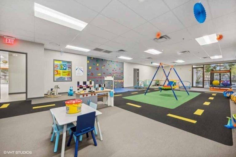 Center-based ABA clinics like this therapy room—with structured play areas, sensory equipment, and observation capabilities—represent the physical infrastructure that Behavioral Framework is expanding through the Autism ETC acquisition.