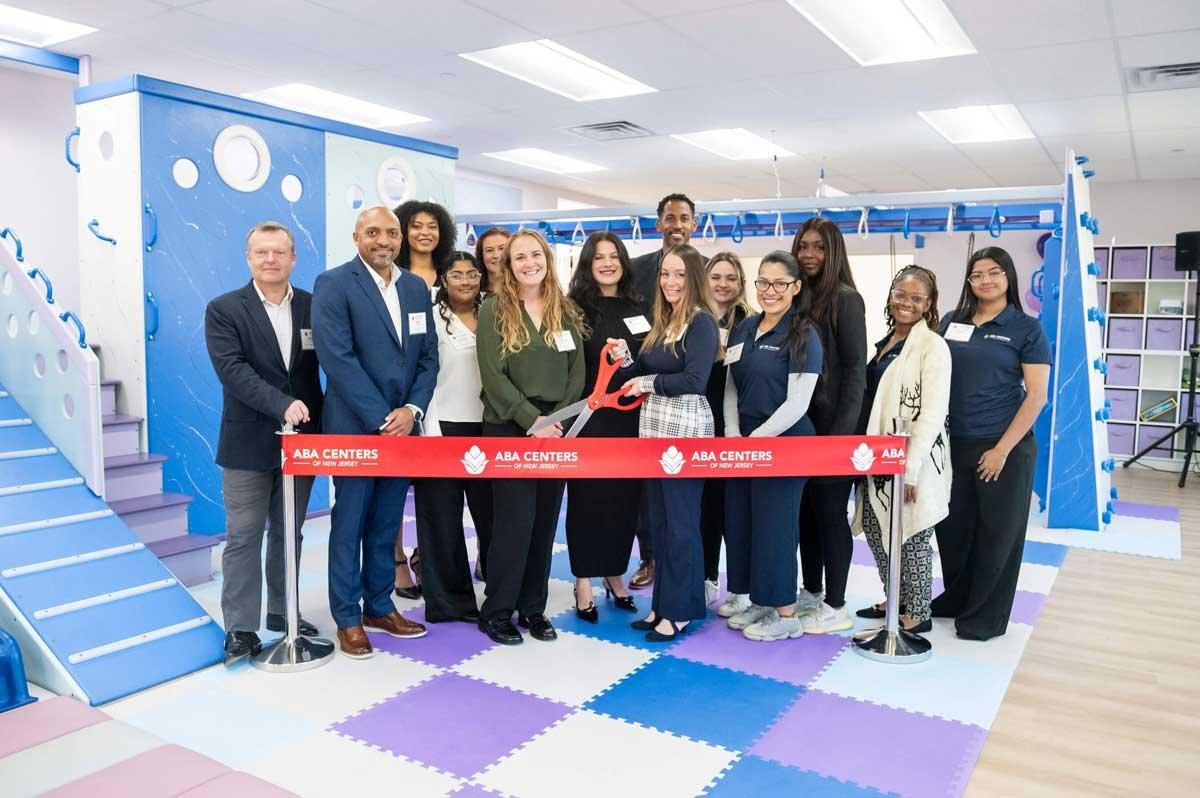 A ribbon-cutting ceremony at a new ABA Centers of New Jersey location illustrates the de novo expansion model, where platforms build new clinics to deepen their presence in established markets.