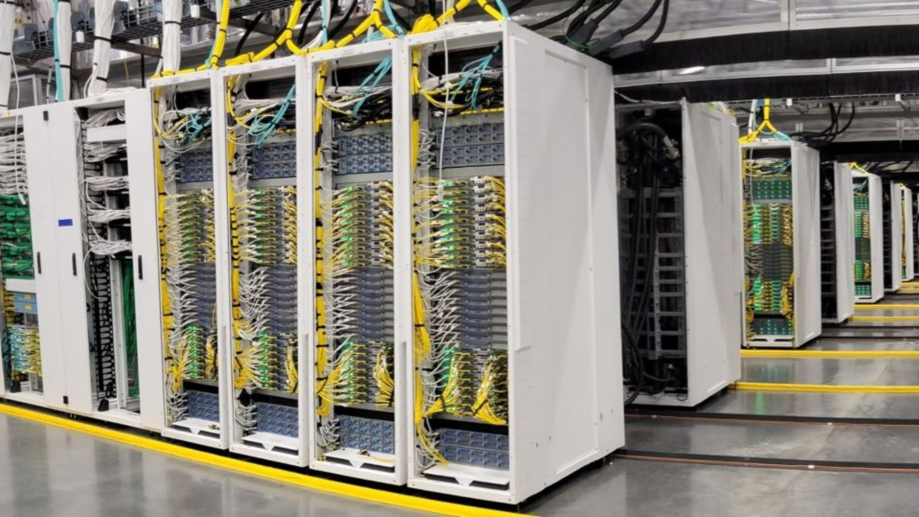 Rows of servers in a commercial data center. The infrastructure question every ABA AI vendor needs to answer is which servers process protected health information, and under what data-handling terms.