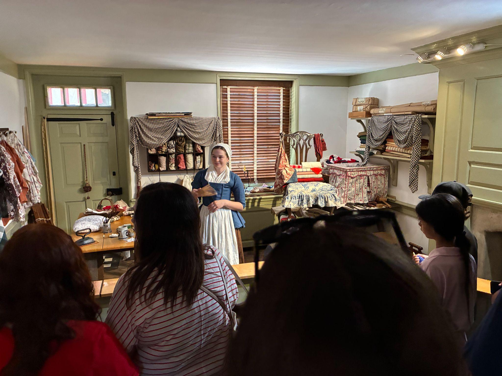 A ghost of Betsy Ross impersonator entertains and informs the crowd about the history of the flag's making.